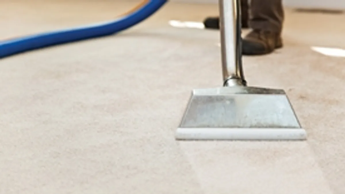 Carpet cleaning wand head gliding over a light carpet during hot-water extraction, Sioux Falls, SD.